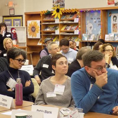 Debbie and her classmates listening to a speaker