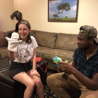 Faith and Emma holding puppets at Robyn Paley's house, a teacher at Loiederman Middle School 