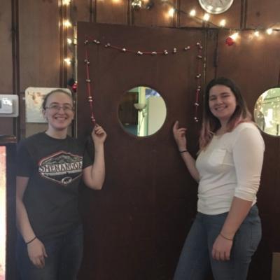 Lelia Vetter and Maddy Dozat next to the decorated door
