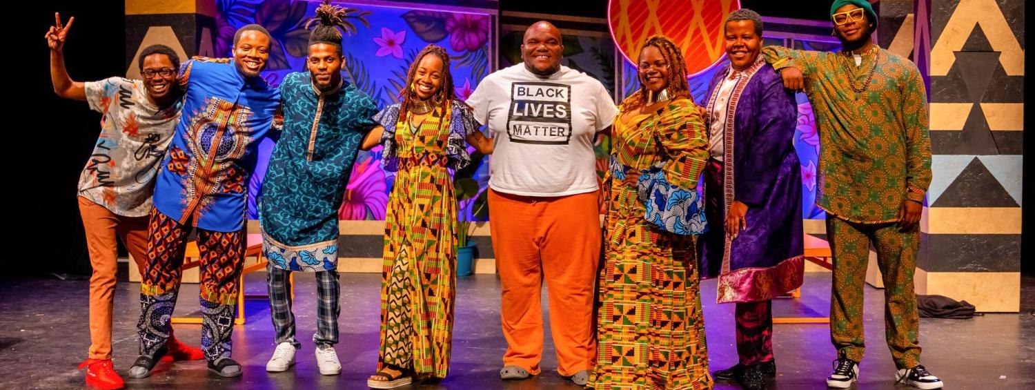 National Players pose in colorful Africana and Afro-futurism-inspired costumes after performing Much Ado About Nothing  by William Shakespeare.