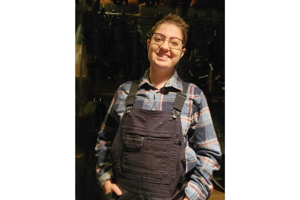 Headshot of Rowan Ethridge in overalls in a catwalk