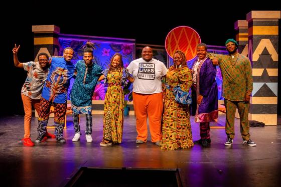 National Players pose in colorful Africana and Afro-futurism-inspired costumes after performing Much Ado About Nothing  by William Shakespeare.